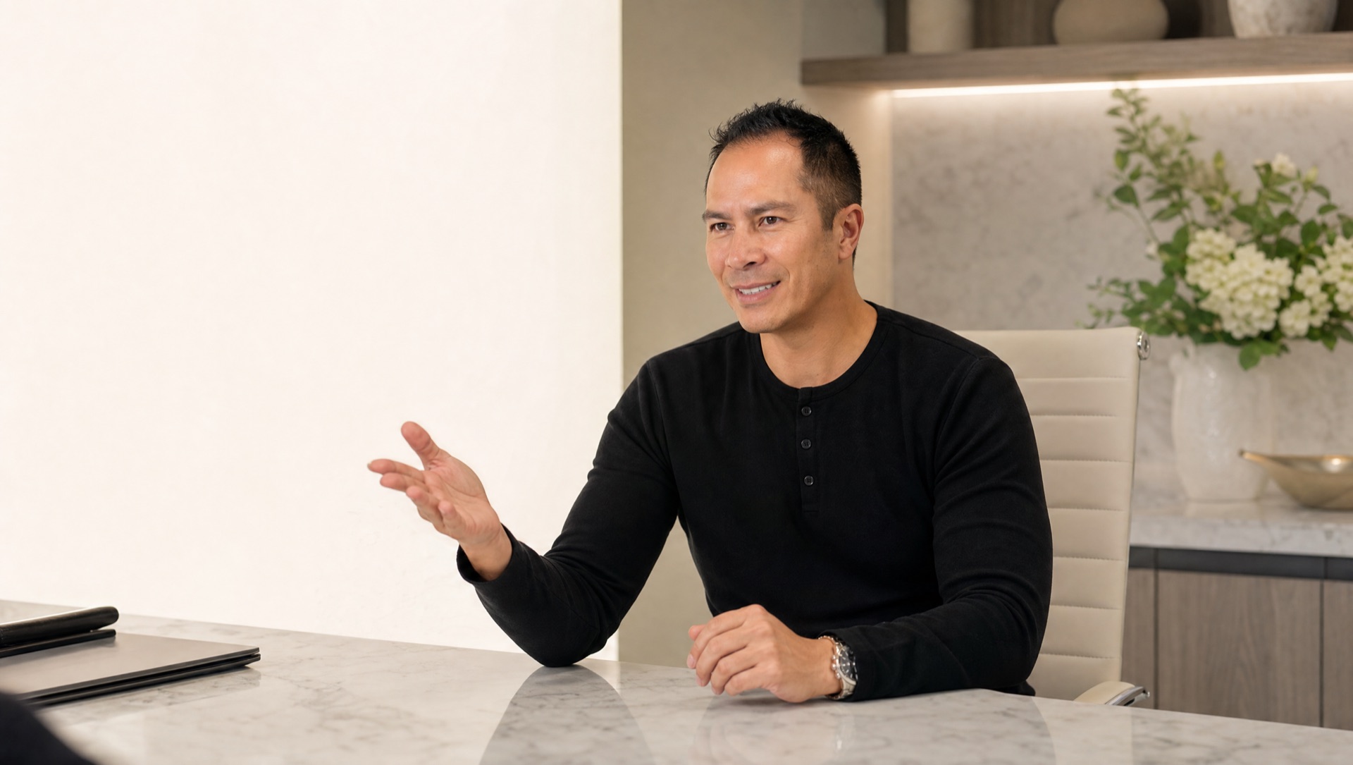 Dr. Castillo seated in a refined medical aesthetic consultation room